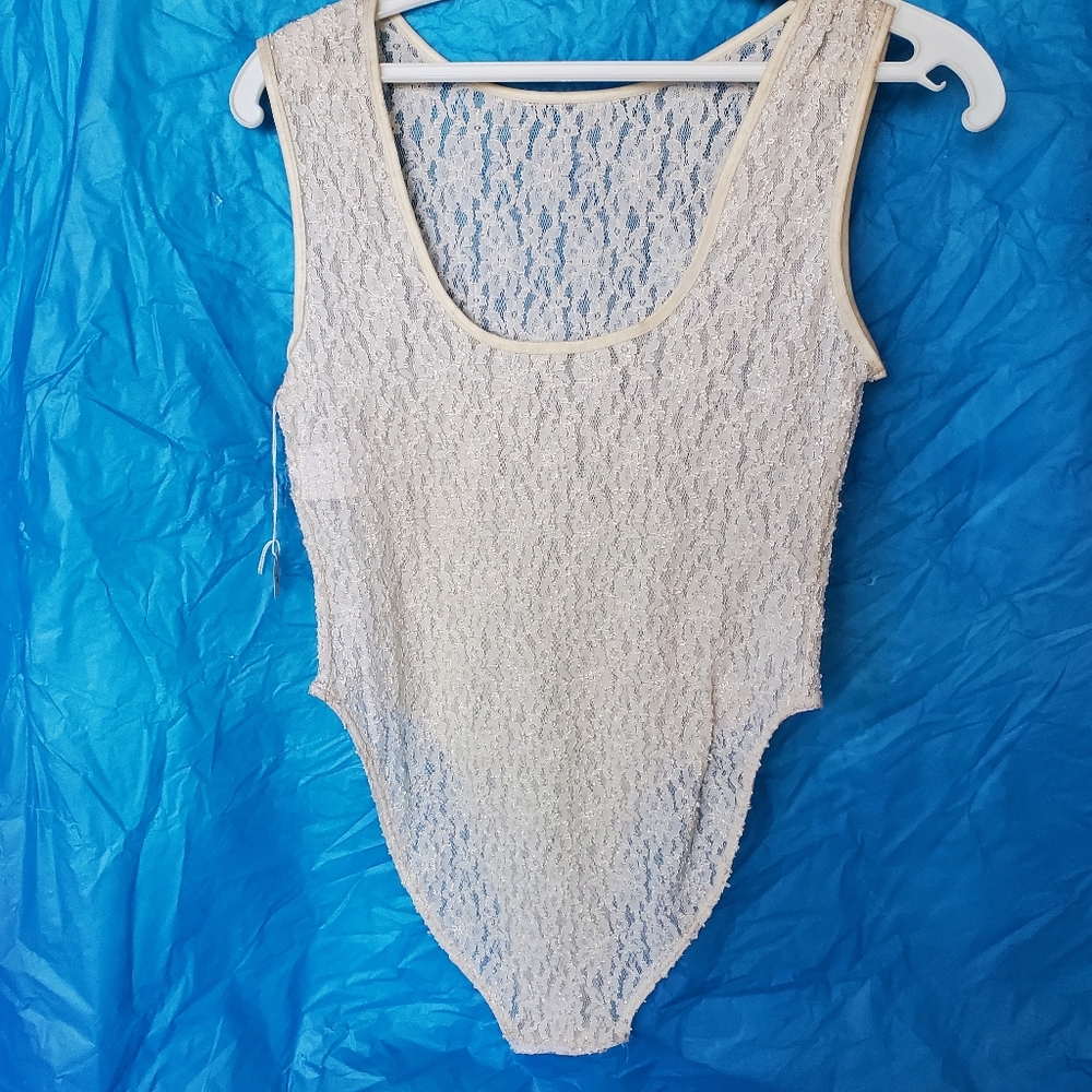 100% nylon Stretch lace body suit. Jewel neckline, back scooped low, snaps Large
